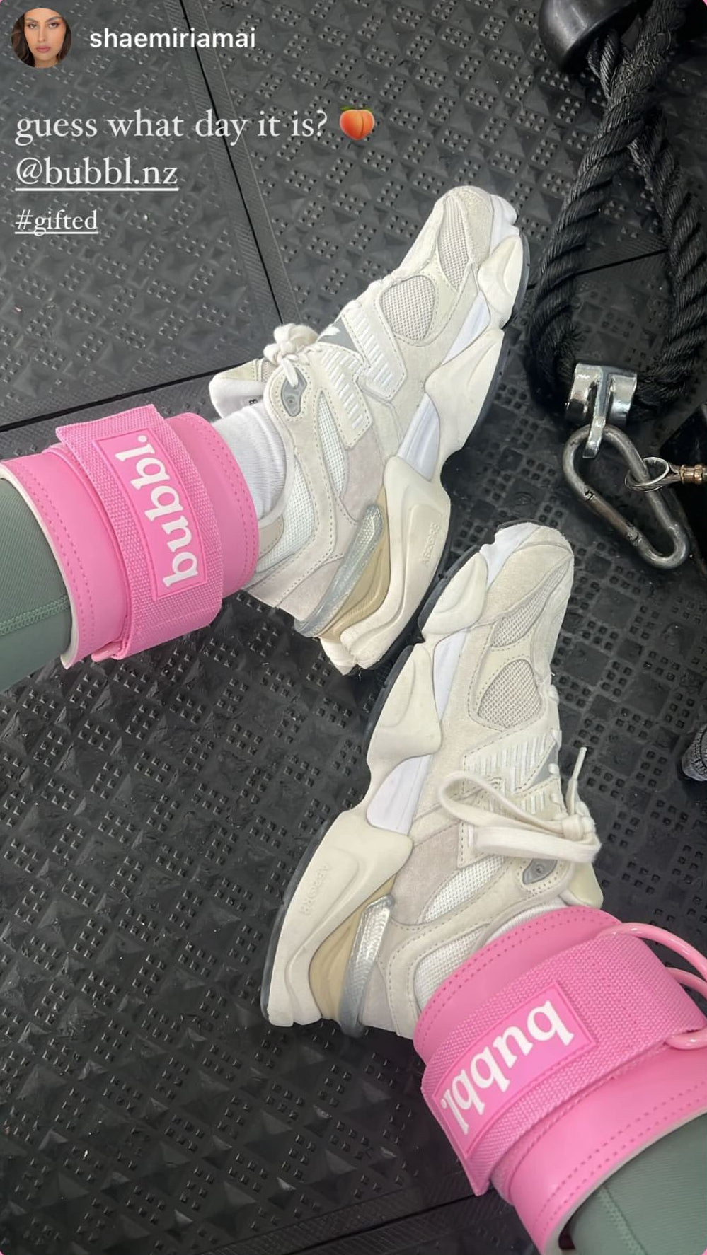 White sneakers with pink ankle supports on a textured surface